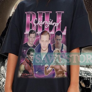 May include: Black oversized t-shirt with a graphic print of Bill Skarsgård from the movie "It" with the text "Bill Skarsgård" in pink.