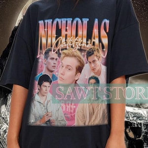 May include: Black oversized t-shirt with a graphic print of a group of men with the text "Nicholas Galitzine" in a retro style.