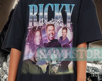 May include: Black oversized t-shirt with a vintage-style graphic of Ricky Martin and the text "RICKY Martin".