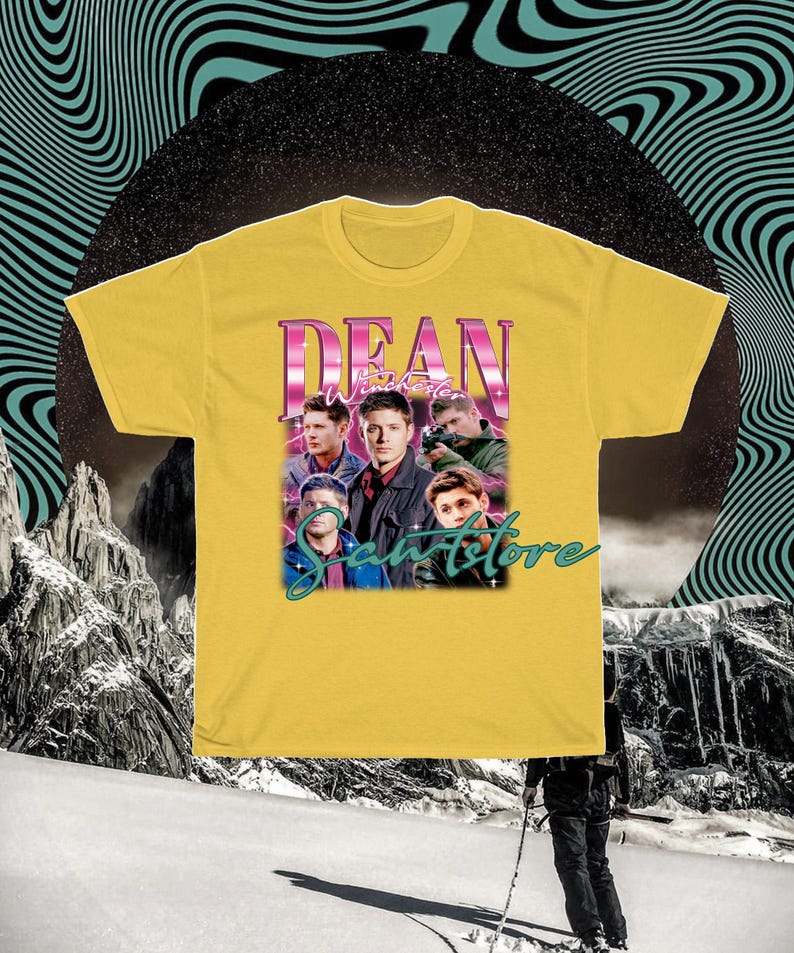 May include: Yellow t-shirt with a retro-style graphic of Dean Winchester from the TV show Supernatural. The graphic features a collage of Dean's face and other characters from the show. The text "Dean Winchester" is in pink and the text "Sawstore" is in green.