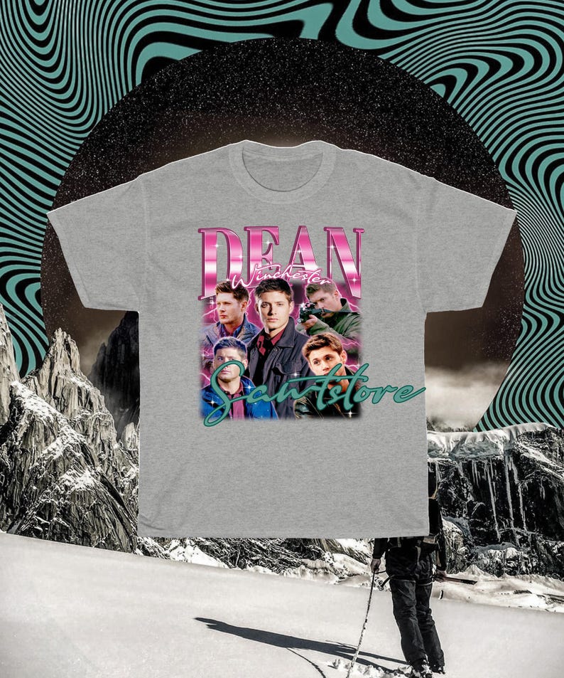 May include: A gray t-shirt with a graphic print of Dean Winchester from the TV show Supernatural. The graphic features Dean and other characters from the show, with the text "Dean Winchester" and "SaveStore" in pink and teal.