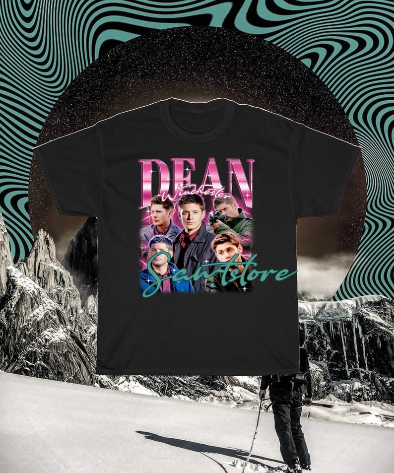 May include: Black t-shirt with a graphic print of Dean Winchester from the TV show Supernatural. The graphic features Dean and other characters from the show in a retro style with the text "Dean Winchester" and "Samstore" in pink and teal.