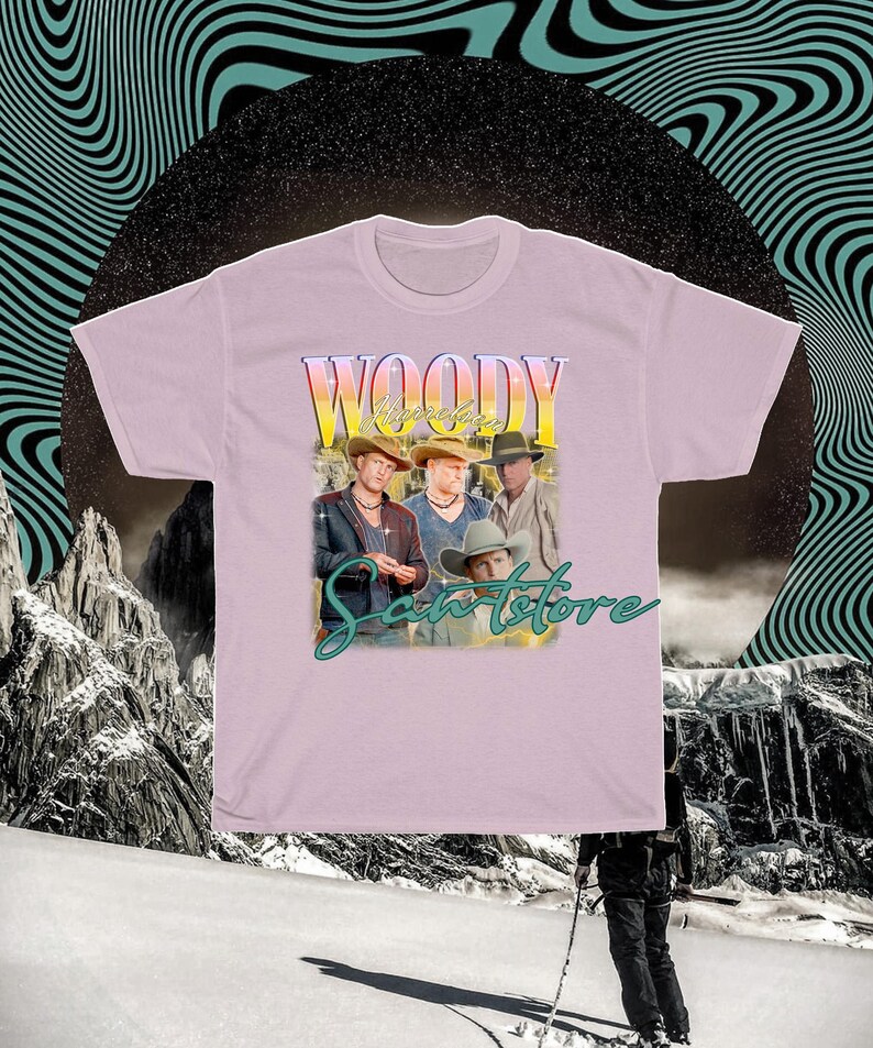 May include: A pink t-shirt with a vintage-style graphic of a band called "Woody & The Saints" with the text "Sanstore" underneath.