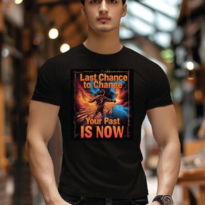 May include: Black t-shirt featuring a graphic print of a person standing on a path with a glowing trail behind them. The text "Last Chance to Change Your Past IS NOW" is printed on the graphic.