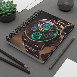 May include: A black spiral bound journal with a gold and black watch on the cover. The watch has a complex design with multiple dials and a green glow. The text "Watch Collectors Journal" is printed on the cover.