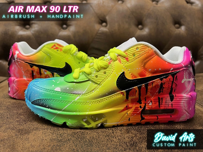 May include: Custom painted Air Max 90 LTR sneakers with a rainbow gradient and black swoosh. The shoes feature a yellow base with pink, orange, and blue accents. The text "David Arts Custom Paint" is visible on the bottom right corner.