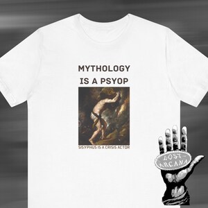 May include: White t-shirt with the text "Mythology is a Psyop" and a painting of Sisyphus pushing a boulder. Below the painting is the text "Sisyphus is a crisis actor". A hand with a round sticker that says "Lost Arcana" is in the bottom right corner.