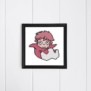 May include: A framed cross-stitch of a cartoon character in a red outfit with pink hair and a white cloud-like shape. The artwork is in a black frame and hangs on a white wall.