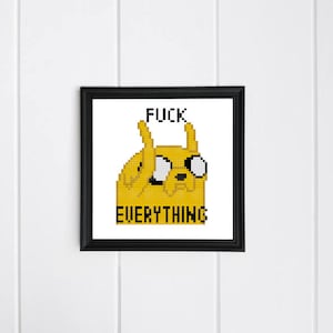 May include: A framed cross-stitch featuring a yellow cartoon character with the text "FUCK EVERYTHING" in black. The artwork is in a black frame and hangs on a white, vertical-slat wall.