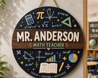 May include: A round, black wooden sign for a math teacher, featuring the name "MR. ANDERSON" and "MATH TEACHER" in white lettering. The sign is decorated with math symbols, equations, and a calculator. It hangs from a jute rope.
