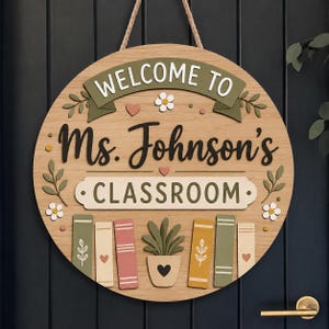 May include: Wooden classroom sign with the text "WELCOME TO Ms. Johnson's CLASSROOM". The sign has a round shape with a light brown background and decorative elements like flowers, hearts, and books. A rope is attached for hanging.