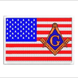 May include: A red, white, and blue American flag with a blue and gold Masonic symbol superimposed on it. The symbol features a compass and square with a letter "G" in the center.