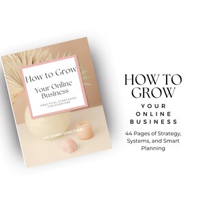 May include: A book titled "How to Grow Your Online Business" with a pink and white cover. The book is on a beige surface with a decorative arrangement including a white sphere, a candle, and a pink crystal. The text reads "Practical Strategies for Everyone."