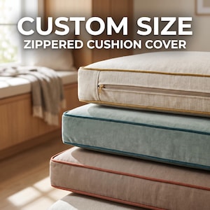 May include: A stack of three rectangular cushion covers with zips and piped edges. The top cover is beige with gold piping, the middle is light blue velvet with dark blue piping, and the bottom is tan with orange piping. Text reads CUSTOM SIZE ZIPPERED CUSHION COVER.