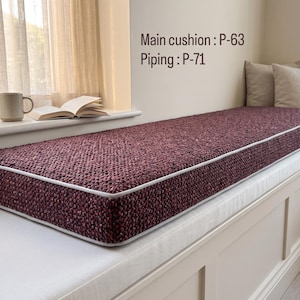 Pode incluir: Uma almofada retangular para banco de janela com tecido texturizado em bord&ocirc; escuro e debrum claro. O texto na parede diz Main cushion : P-63 e Piping : P-71. A almofada est&aacute; posicionada sobre um banco embutido de cor branca.