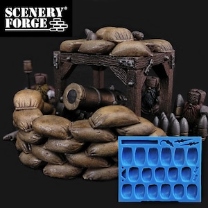 May include: A set of 18 sandbag molds for creating miniature terrain for tabletop wargaming. The molds are made of blue silicone and are arranged in a rectangular grid. The molds are shown next to a miniature cannon and sandbag fortifications.