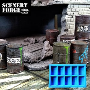 May include: A blue silicone mold for making miniature barrels. The mold has nine compartments, each shaped like a barrel. The mold is sitting on a table with several miniature barrels in the background.