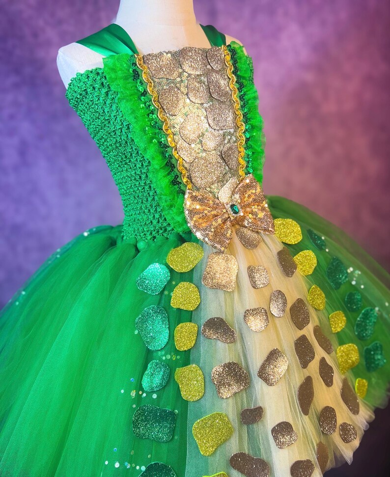 May include: A white ceramic mug with a black handle and the text "But First, Coffee" in a black, bold font. The mug is on a white surface.