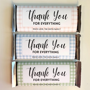 May include: Three chocolate bars wrapped in different colored gingham patterns. Each bar has a white label with the text "Thank You For Everything" and "Much Love, The Smith Family".