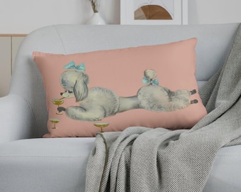 May include: A pink throw pillow with a white poodle wearing a blue bow and holding a champagne glass. There are three additional champagne glasses on the pillow.
