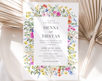 May include: A wedding invitation with a floral border featuring colorful wildflowers. The invitation includes the names "Sienna and Tristan" and event details. The design is set against a white background with a dried palm leaf.