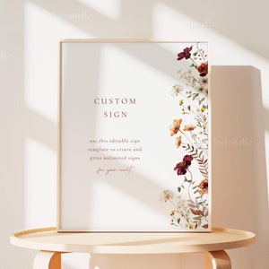 Könnte beinhalten: Ein gerahmtes, druckbares Schild mit einem floralen Design und dem Text "CUSTOM SIGN" und "use this editable sign template to create and print unlimited signs for your event".