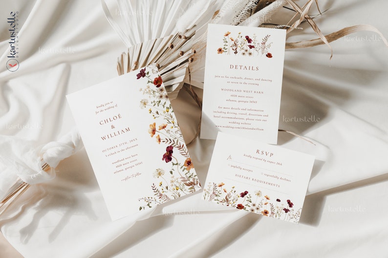 May include: Wedding invitation suite with a floral design featuring burgundy, orange, and white flowers. The invitation includes the names Chloe & William, the date October 17th, 2023, and the time 4 o'clock in the afternoon. The details card includes the venue, Woodland West Barn, 3010 Main Street, Atlanta, Georgia 30311. The RSVP card includes a space for guests to indicate their attendance and dietary requirements.