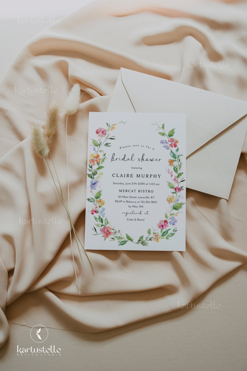 Puede incluir: Una invitaci&oacute;n de ducha nupcial floral con una corona de acuarela de flores rosas, amarillas y moradas. La invitaci&oacute;n es para Claire Murphy e incluye la fecha, la hora y el lugar de la ducha. Tambi&eacute;n indica que la invitada de honor est&aacute; registrada en Crate & Barrel.