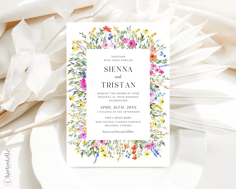 May include: A wedding invitation with a floral border featuring colorful wildflowers in shades of pink, yellow, orange, and blue. The invitation includes the names Sienna and Tristan, along with the wedding date, time, and location.