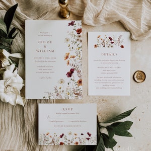 May include: Wedding invitation suite with floral designs in shades of burgundy, red, and white. The invitation card features the text "kindly join us for the wedding of CHLO&Eacute; & WILLIAM" and the date "OCTOBER 27TH, 20XX". The details card includes the time and location of the wedding reception. The RSVP card has a floral design and the text "kindly respond by August 20th".