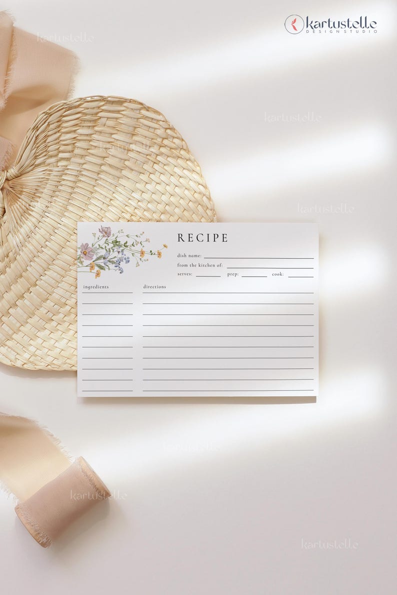 May include: A recipe card with floral accents and the word "RECIPE" at the top. The card has lines for ingredients, directions, and other details. A woven fan and ribbon are in the background.