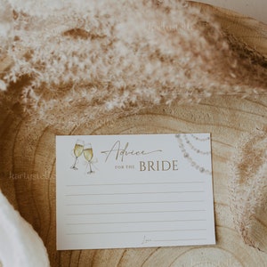May include: White card with gold text that reads "Advice for the Bride". The card has a watercolor illustration of two champagne flutes and a pearl necklace.