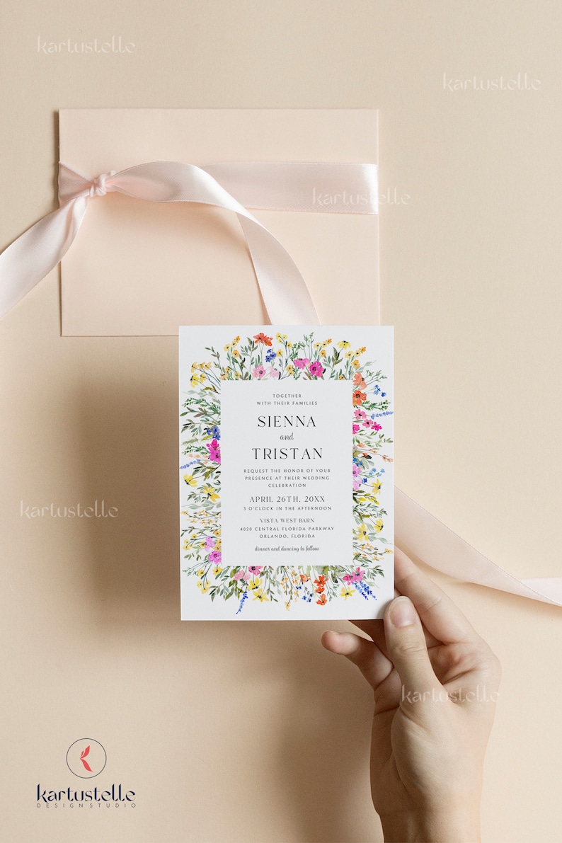 May include: Wedding invitation featuring a floral border with colorful wildflowers. The invitation includes the names Sienna and Tristan, along with the wedding date, time, and location. A matching envelope with a pink ribbon is also shown.