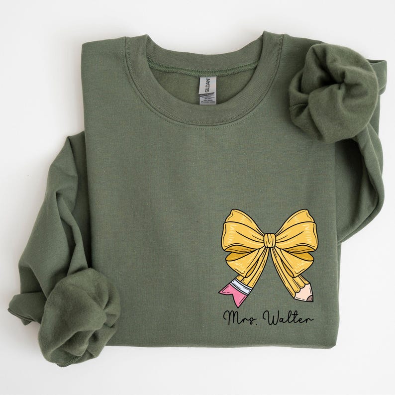 a green shirt with a yellow bow on it