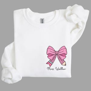 custom name teacher pink coquette bow pencil sweatshirt with pocket size design