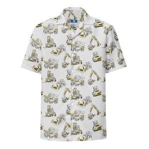 May include: A short-sleeve button-down shirt in white featuring an all-over print of yellow and grey construction vehicles, including excavators and dump trucks. The shirt has a classic collar and a small blue tag at the neck with the text YTS.