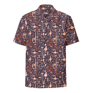 May include: A short-sleeved button-down shirt with a dark purple background and a repeating pattern of various tools in shades of brown, orange, and pink.