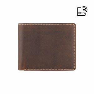May include: A brown leather wallet with a stitched edge. The wallet has RFID blocking technology.