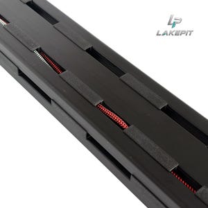 May include: A black metal track featuring a series of rectangular cutouts along its length. Inside the track, a thin red coiled wire is visible. The logo for LAKEPIT is printed in the upper right corner of the image in black and blue text.