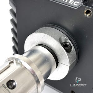 May include: A black mechanical housing with a silver cylindrical shaft attached via a circular silver clamp. The clamp features a visible black hex bolt. The black housing has a ribbed side and the partial text "TEC" at the top and "LAKEPIT" logo.