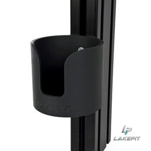May include: A black cylindrical cup holder with a U-shaped cutout on the front, featuring the embossed text LAKEPIT. The holder is attached to a vertical black aluminium extrusion profile. A small silver screw is visible inside the cup holder.