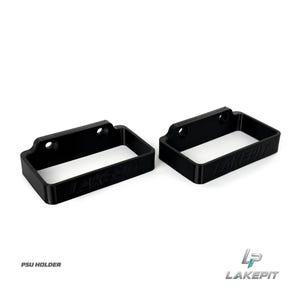 May include: Two black rectangular PSU holder brackets made of rigid material. Each bracket features two circular mounting holes along the top edge and the embossed text LAKEPIE on the front side. The design is open-ended for mounting purposes.