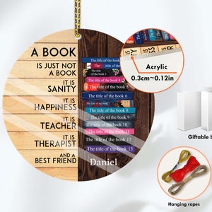 May include: A round wooden ornament with the text "A book is just not a book. It is sanity. It is happiness. It is teacher. It is therapist and a best friend. Daniel" printed on it. The ornament is 0.3 inches thick and comes with a gift box and hanging ropes.