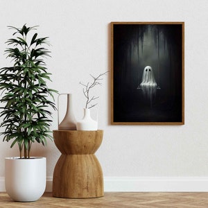 May include: A framed illustration of a white ghost sitting on a swing in a dark, shadowy forest. The ghost has two black eyes and a simple, white, draped form.