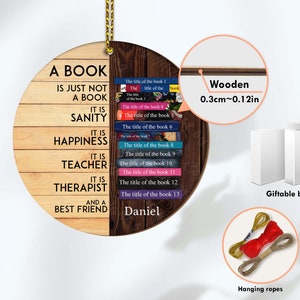 May include: A round wooden sign with the text "A book is just not a book. It is sanity. It is happiness. It is teacher. It is therapist. And a best friend." The sign is decorated with a stack of books and the name "Daniel". The sign is 0.3 inches thick and comes with a gift box and hanging ropes.