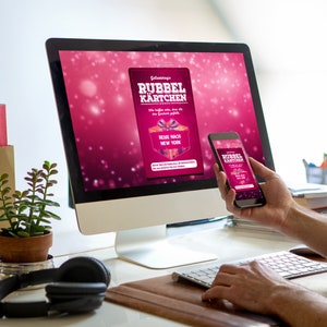 K&ouml;nnte beinhalten: Ein Computerbildschirm und ein Smartphone zeigen eine pinkfarbene und wei&szlig;e Werbung f&uuml;r "Gewinnspiel's Rubbelkarten" mit dem Text "Reise nach New York".