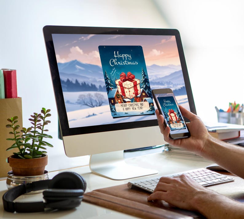 May include: A computer screen and a smartphone both display a digital Christmas card with a red and white gift box, a house, and the text "Happy Christmas" and "Merry Christmas and a Happy New Year".
