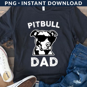 May include: Black t-shirt with a white graphic of a pitbull wearing sunglasses and the text "Pitbull Dad".