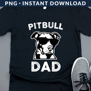 May include: Black t-shirt with a white graphic of a pitbull wearing sunglasses and the text "Pitbull Dad".