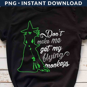May include: Black t-shirt with a green silhouette of the Wicked Witch of the West holding a broom. The text "Don't make me get my flying monkeys" is written in white.